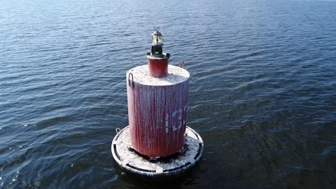 Aerial view. Red floating navigation sign in waterway of a wide navigable river. Stock-Footage 97853902