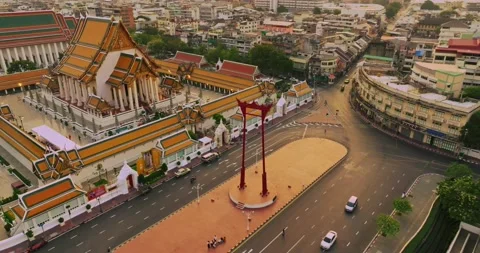 An aerial view of Red Giant Swing and Suthat Thepwararam Temple at sunset sce Stock Footage 227690481