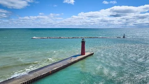 Aerial View of Red Lighthouse on Pier by Turquoise Waters Stock Photos