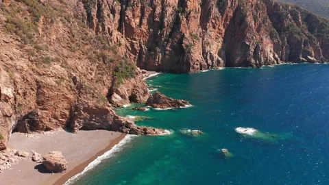 Aerial view of red rock cliffs mountain, sand beach, waves crushing on the beach 動画素材 157304531