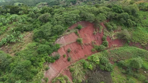 Aerial view of red soil erosion and landslide near agricultural fields. Stock Footage 340515145