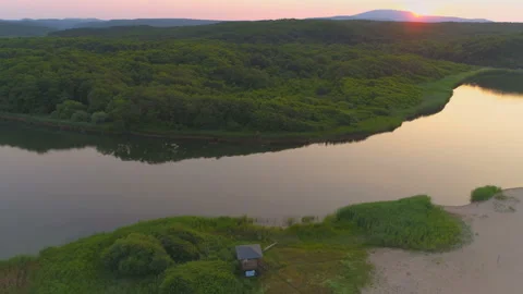 Aerial view of red sunset over mountains, green forests and Veleka river mouth Stock Footage 135037354