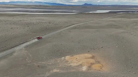 Aerial View Of Red SUV Driving On Remote Iceland Gravel Road Stock Footage 343077656