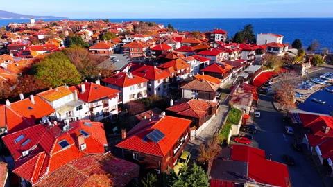 Aerial view of red tiled roofs in old coastal town Video stock 327930100
