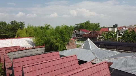 Aerial view of red-tiled rooftops and greenery Stock-Footage 279308069