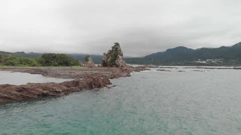 Aerial view of a red Torii Gate at small rocky island, Katsuura, Wakayama, Japan Stock Footage 201266466