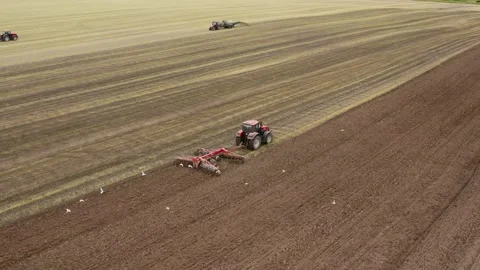 Aerial View. Red tractor plows a field in spring. Stock Footage 131310069