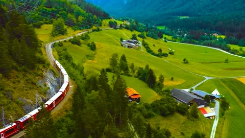 Aerial View of Red Train Curving Through Summer Mountain Valley Stock Footage 346731168
