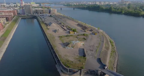 Aerial view of a redevelopment site at a river harbor for urban expansion Video stock 329681028