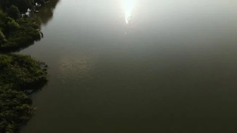 Aerial view of Reflection Lake in Valley near to Hills, with Village and Park Stock Footage 162621904