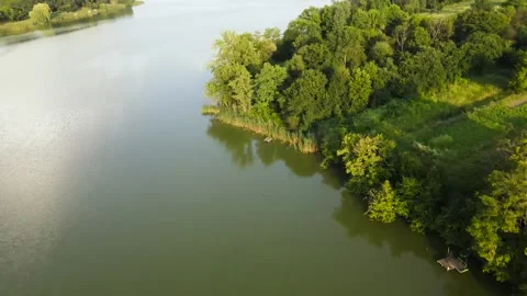 Aerial view of Reflection Lake in Valley near to Hills, with Village, Park Stock Footage 162621936