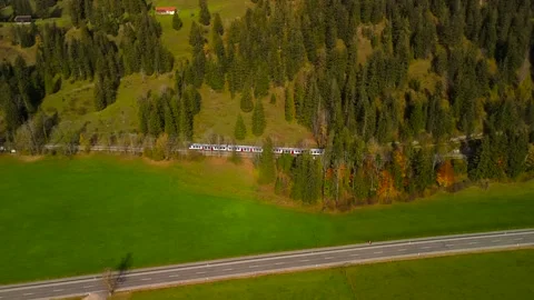 Aerial view of regional train approaching picturesque Bayrischzell station Stock Footage 316664194