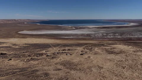 Aerial view of a remote ghost town and salty Aral sea in a desert landscape Stock Footage 323008072