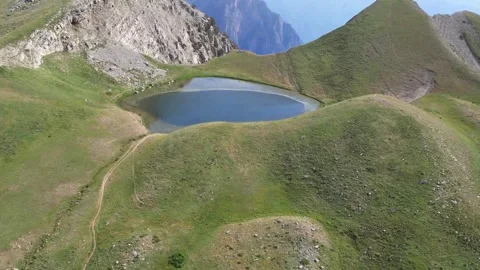 Aerial View of a Remote High-Altitude Lake in Summer Stock Footage 303399445
