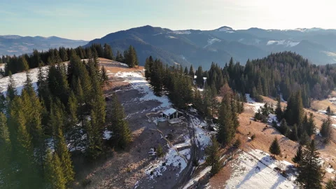 Aerial view Remote mountain cabin on a scenic hilltop, surrounded by pine trees Stock Footage 304128681
