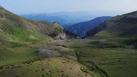Aerial View of Remote Mountain Valley in Summer Stock Footage 303399455