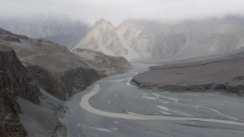 Aerial view of a remote river valley in Pakistan, showcasing rugged mountains Stock-Footage 314455173
