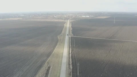 Aerial view of a remote road in a plain Stock Footage 258656977