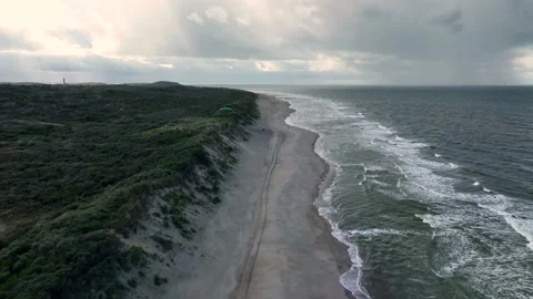Aerial view of a remote, sandy beach in Holland on a cloudy day Stock Footage 217440649