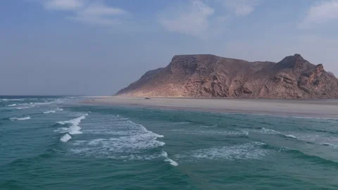 Aerial view of a remote sandy beach with turquoise ocean waves, Socotra island Stock Footage 335162627