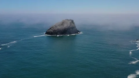 Aerial View of a Remote Sea Stack and Marine Layer in Northern California Video stock 111834212