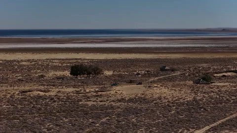Aerial view of a remote settlement in an arid desert landscape, Aral sea Stock Footage 323007997