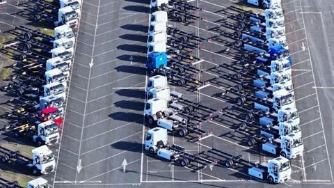 Aerial View of Renault Trucks Aligned in Sunlit Parking Lot at Gare A6 Stock Footage 333319229