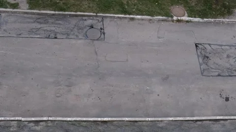 Aerial view of a repaired rectangular pothole patch on a city street asphal.. Stock Footage 339802037