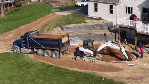 Aerial view of residential backyard pool construction in USA with excavator and Stock Footage 333923351