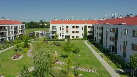 Aerial View of Residential Complex Courtyard with Green Roofs and Amenities Stock Footage 309529256