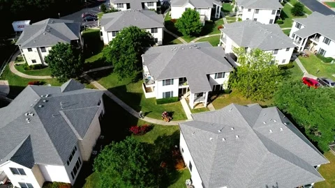 Aerial View of Residential Complex with Gray Roofs and Lush Green Landscaping Stock Footage 311726184