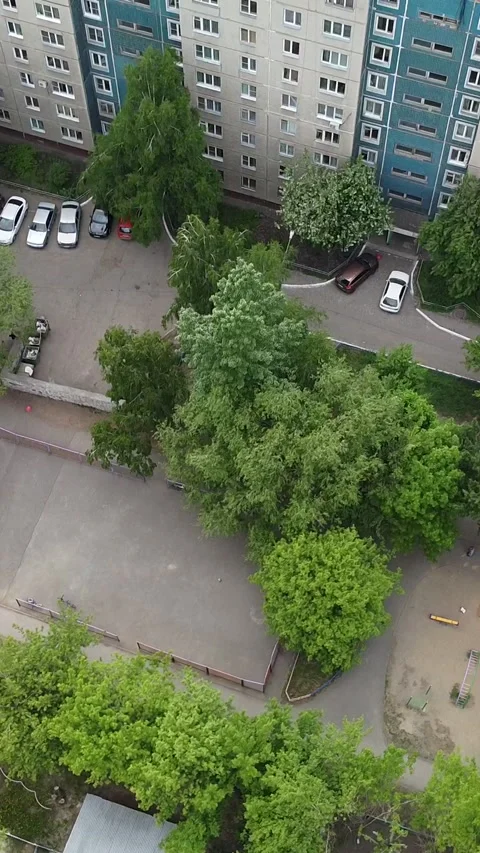 Aerial view of a residential complex with trees and cars Stock Footage 347497579