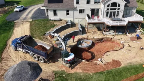 Aerial view of residential pool construction in American suburb with excavator Stock Footage 333717234
