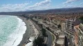 Aerial view of resort city spread along ocean coast, people sunbathing on beach 4k or 4k+ Resolution