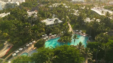 Aerial view of a resort pool at sunset in Punta Cana Stock Footage 306267079