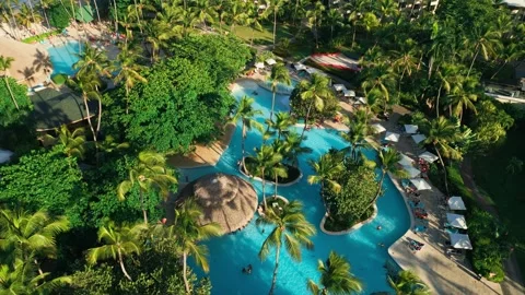 Aerial view of a resort swimming pool at sunset in Impressive Punta Cana Video stock 308334090