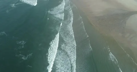 Aerial view of rhythmic waves on a sandy beach The Concept of coastal rhythm Stock Footage 336927381