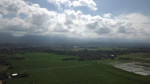 Aerial View of Rice Fields and Mountain Landscape Under Dramatic Clouds Stock Photos