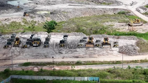 An aerial view of rigid dump trucks and excavators parked in a row at a coa.. Stock Footage 343247219