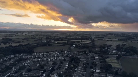 Aerial view, rise up move. Dramatic sunset over residential area of town Stock Footage 95563738