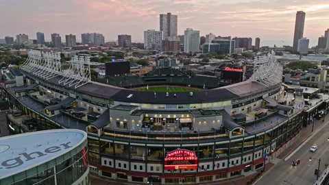 Aerial view rising in front of the Wrigley Field stadium, sundown in Stock Footage 252129092