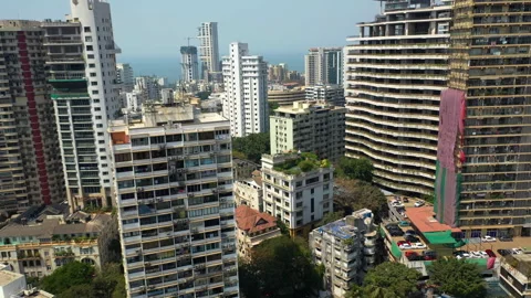 Aerial view rising in middle of decayed skyscrapers in sunny Mumbai, India 스톡 동영상 269753539