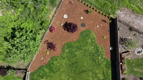 Aerial view rising over backyard landscaping with lush green grass and fres.. Stock Footage 337402706