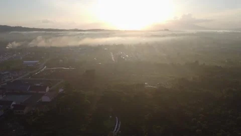 Aerial view of the rising sun behind the mountains in the town of Batulicin.. Stock-Footage 246541904