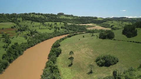 Aerial view of a river amid green fields and trees. 4K. Drone. Stock Footage 233219637