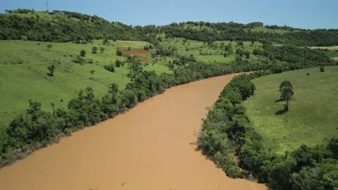 Aerial view of a river amid green fields and trees. 4K. Drone. Stock Footage 233219638