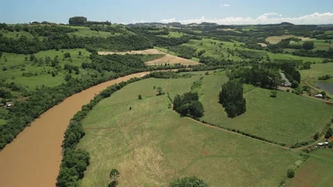 Aerial view of a river amid green fields and trees. 4K. Drone. Stock Footage 233219640