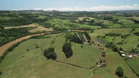 Aerial view of a river amid green fields and trees. 4K. Drone. Stock Footage 233219655