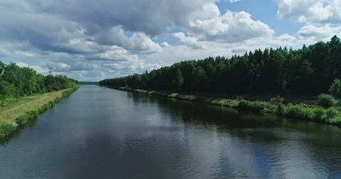 Aerial view of river and forest at summer day, sky reflecting in water Stock Footage 157833795
