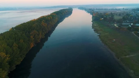 Aerial view of a river and its left coast covered in fog. Stock Footage 114425328
